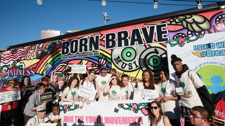 LOS ANGELES, CA - JANUARY 21:  Dr. Robert Ross (C, in hat) and attendess pose at the Born This Way Foundation's "Born Brave Bus" Pre-show Tailgate Party at STAPLES Center on January 21, 2013 in Los Angeles, California.  (Photo by David Livingston/Getty Images)