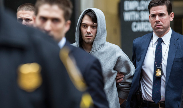NEW YORK, NY - DECEMBER 17:  Martin Shkreli (C), CEO of Turing Pharmaceutical, is brought out of 26 Federal Plaza by law enforcement officials after being arrested for securities fraud on December 17, 2015 in New York City. Shkreli gained notoriety earlier this year for raising the price of Daraprim, a medicine used to treat the parasitic condition of toxoplasmosis, from $13.50 to $750 though the arrest that happened early this morning does not involve that price hike.  (Photo by Andrew Burton/Getty Images)